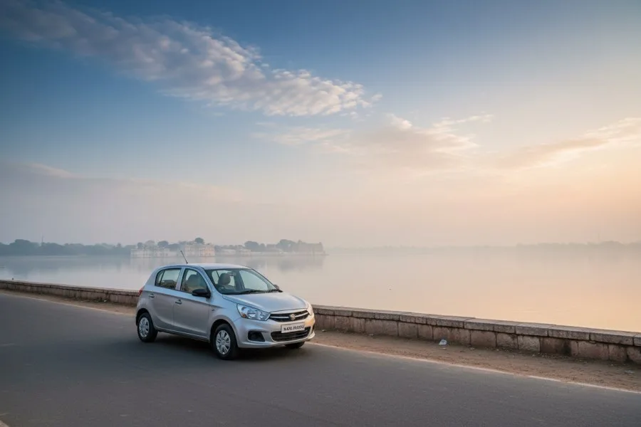 A quiet lakeside road in Udaipur at dawn with a car beside the water